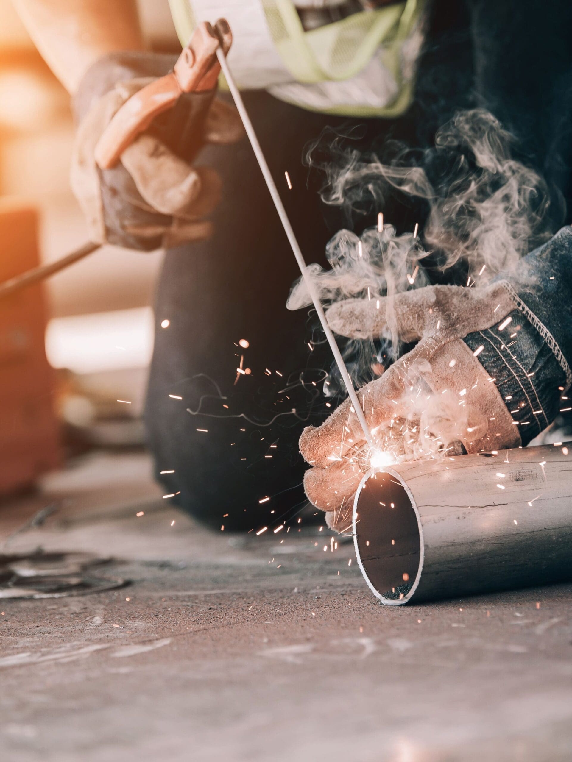 Welder in protective uniform and mask