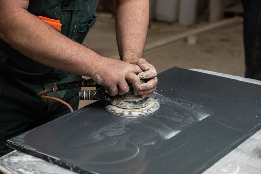 polishing the surface of the facade with a grinder